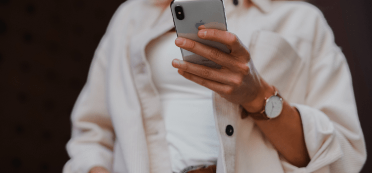 woman using iphone in white shirt