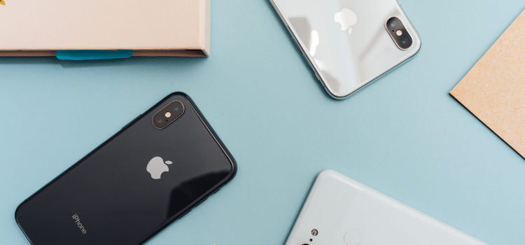 iphones on light blue desk