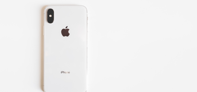 white iphone on table