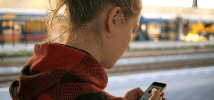 woman using phone on the street