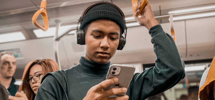 woman on training using iphone with headphones in