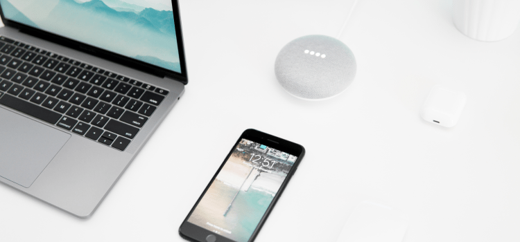 phone and laptop on white desk