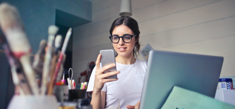 lady using phone at art desk