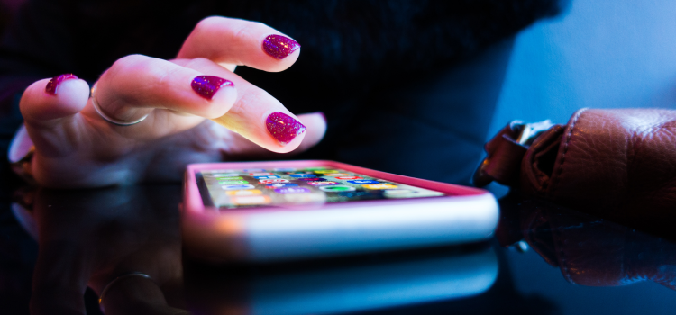 person using smart phone on table